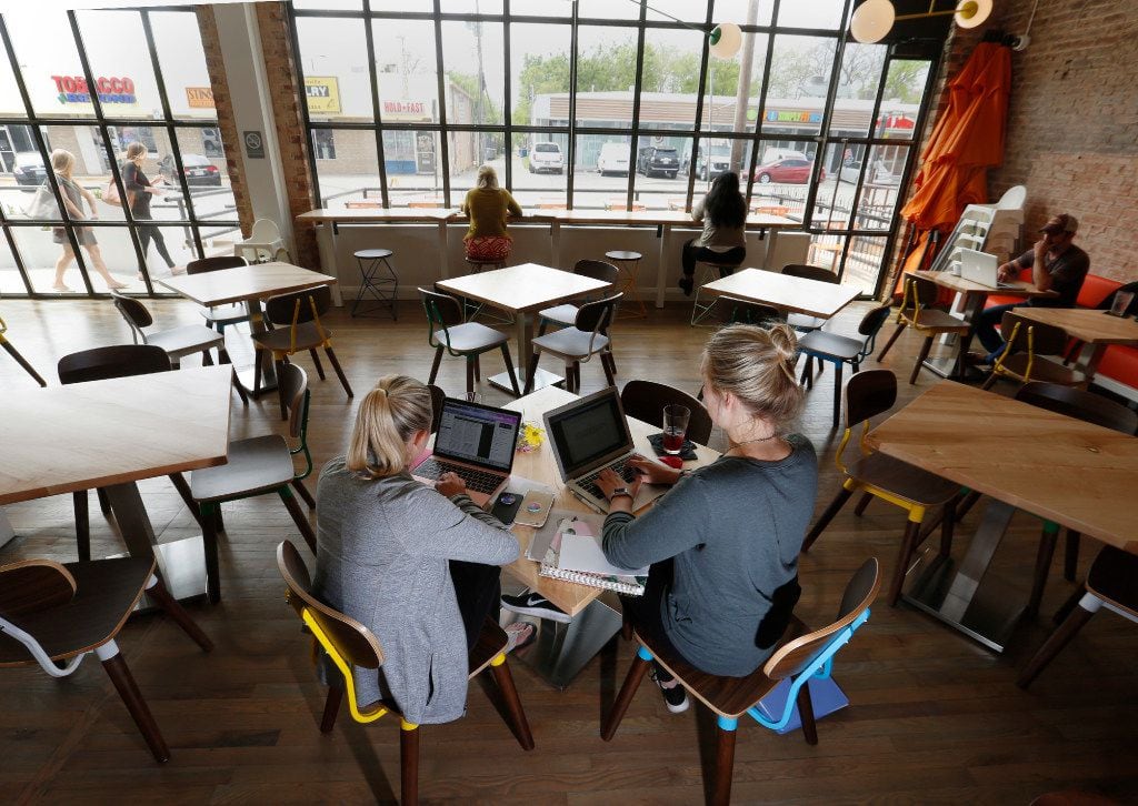 SMU graduate students, Taylor Cox, left and Shelby Smith, study in the dinning area at the...