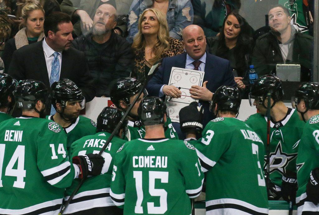 Dallas Stars head coach Jim Montgomery talks to the team during a timeout in the third...