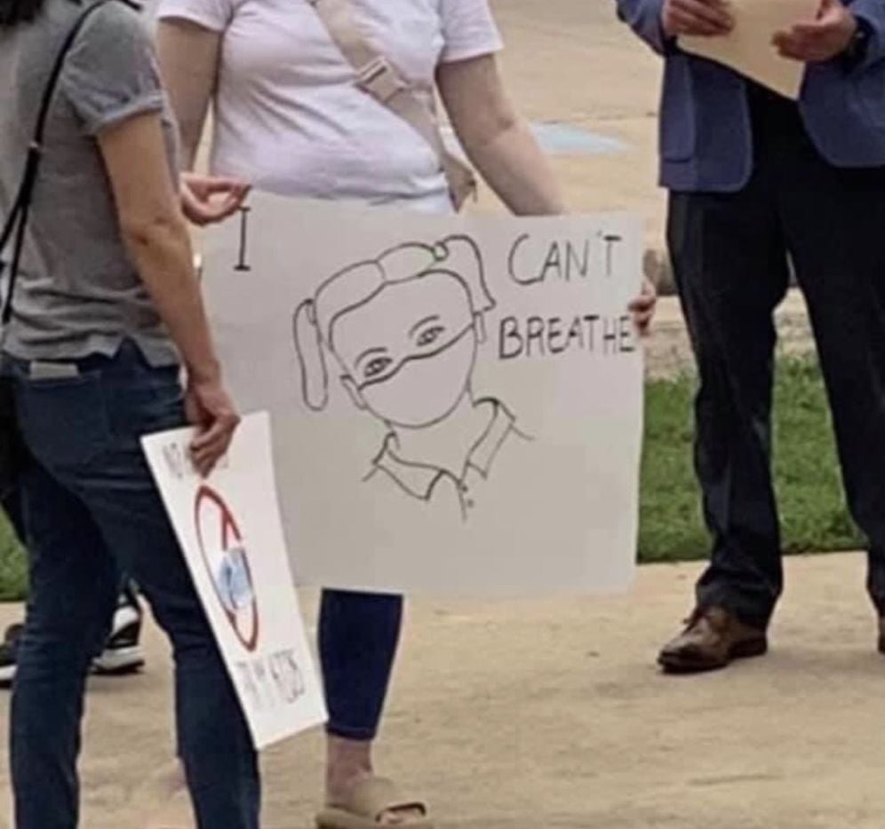 Protesters held "I can't breathe" signs outside the Carroll ISD board meeting Monday night, two days after two trustees who oppose the district's cultural competence plan were elected.
