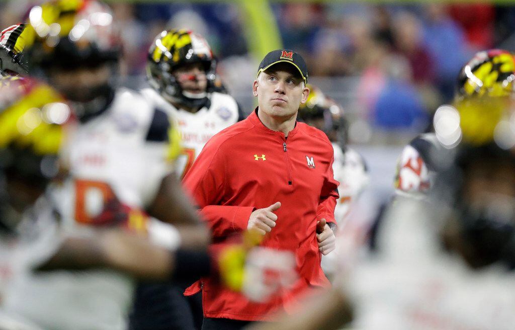 FILE - In this Monday, Dec. 26, 2016 file photo, Maryland head coach DJ Durkin runs onto the...