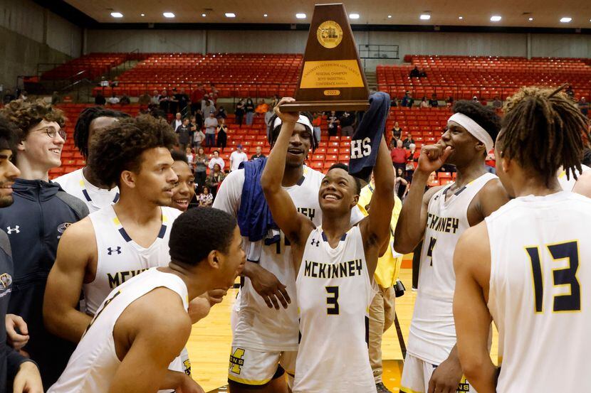 McKinney’s Jacovey Campbell  (3) holds the championship trophy after defeating Arlington...