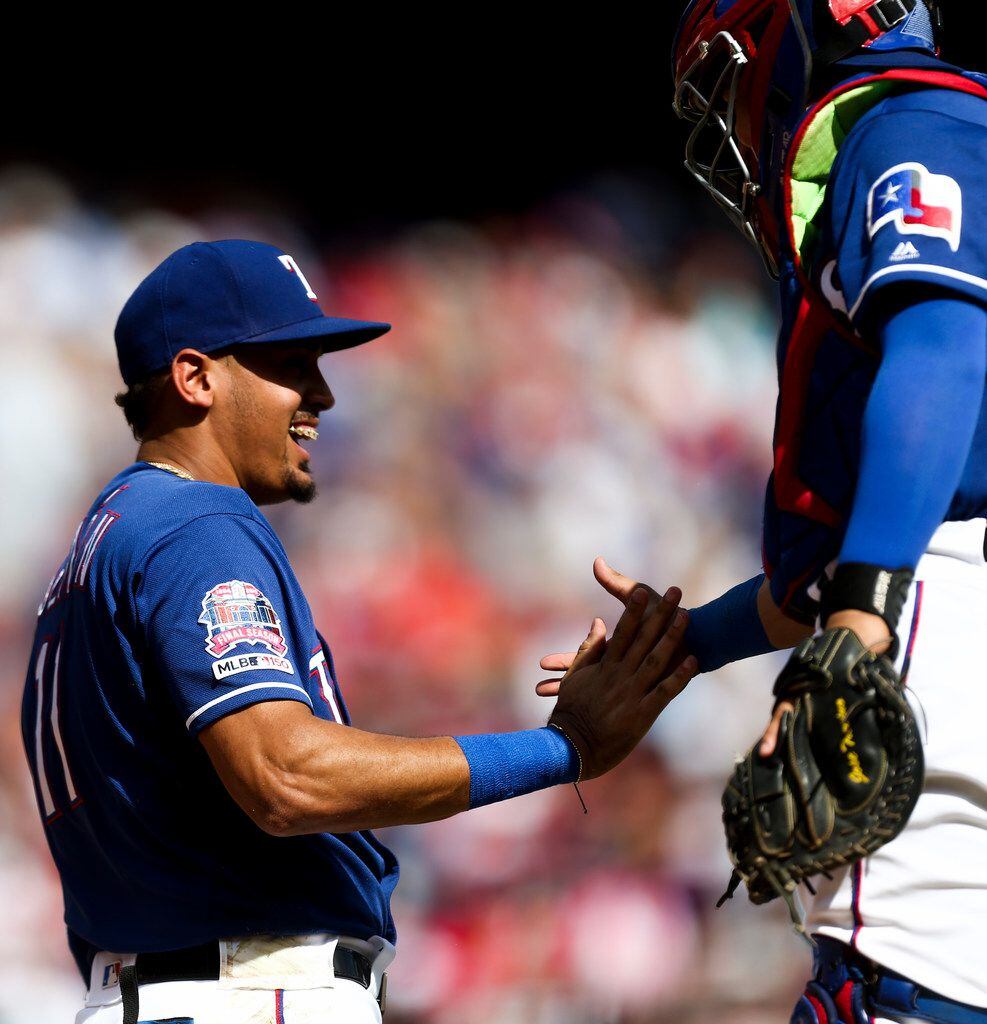 Texas Rangers first baseman Ronald Guzman (11) shares a moment with catcher Jose Trevino...