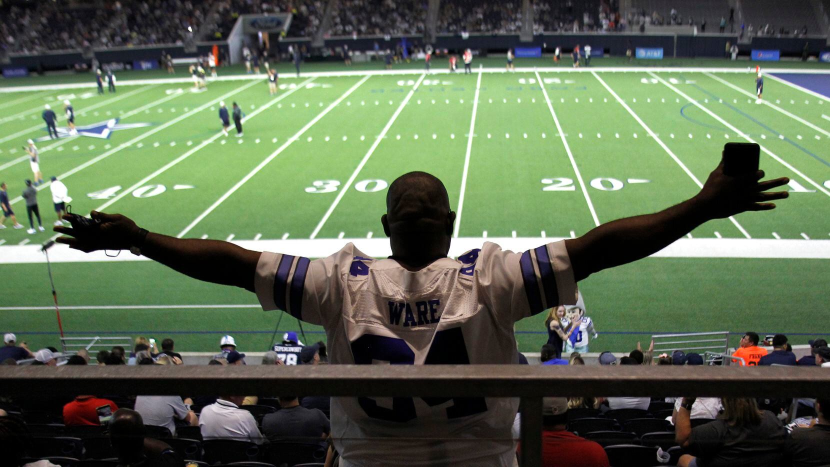 Dallas Cowboys fan Darrell Glenn takes in the team's final public practice of training camp....