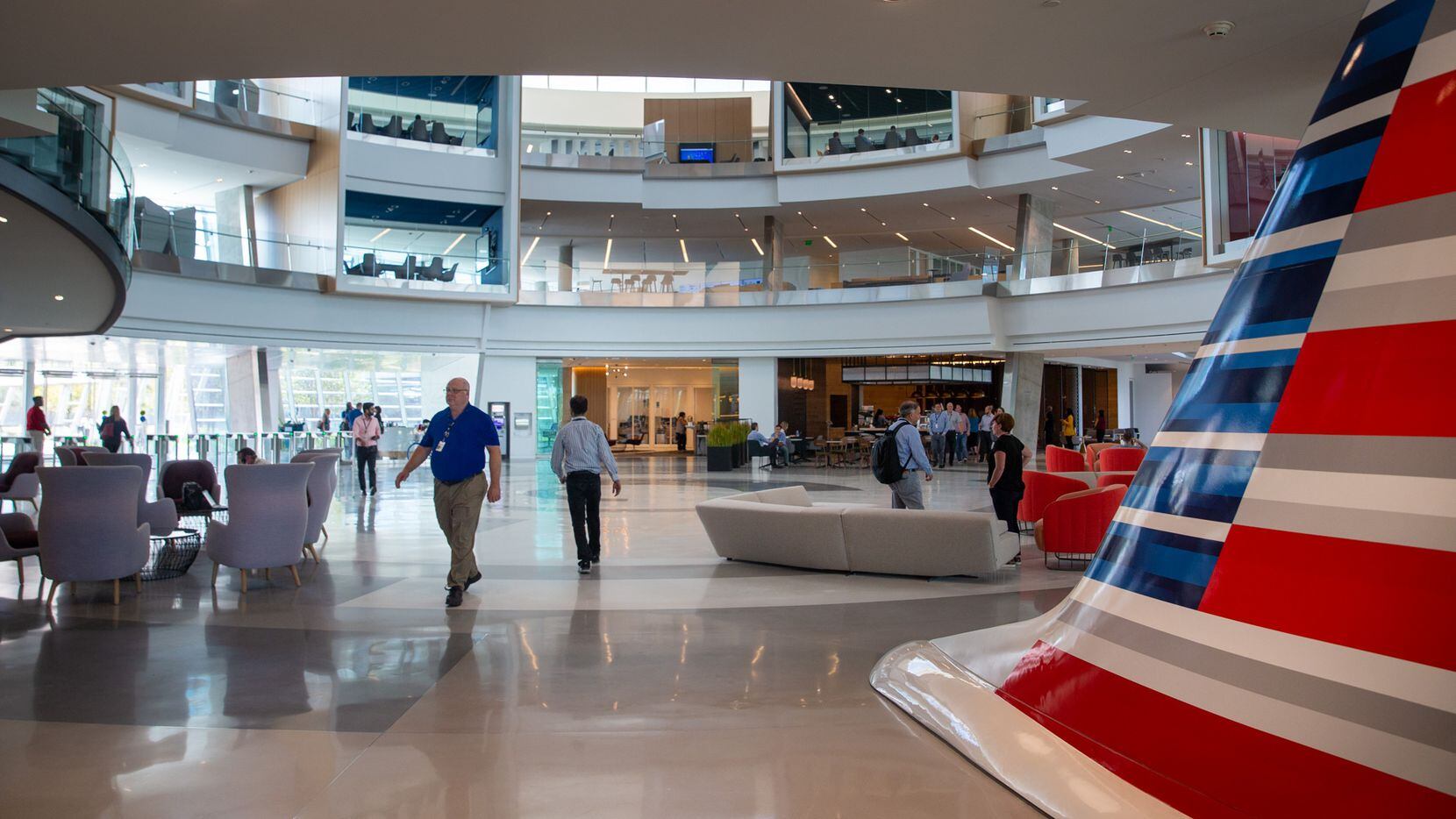 Employees walk through the main lobby of the Skyview 8 building at the new American Airlines campus and headquarters in Fort Worth, Texas, on Monday, Sep. 23, 2019. (Lynda M. Gonzalez/The Dallas Morning News)