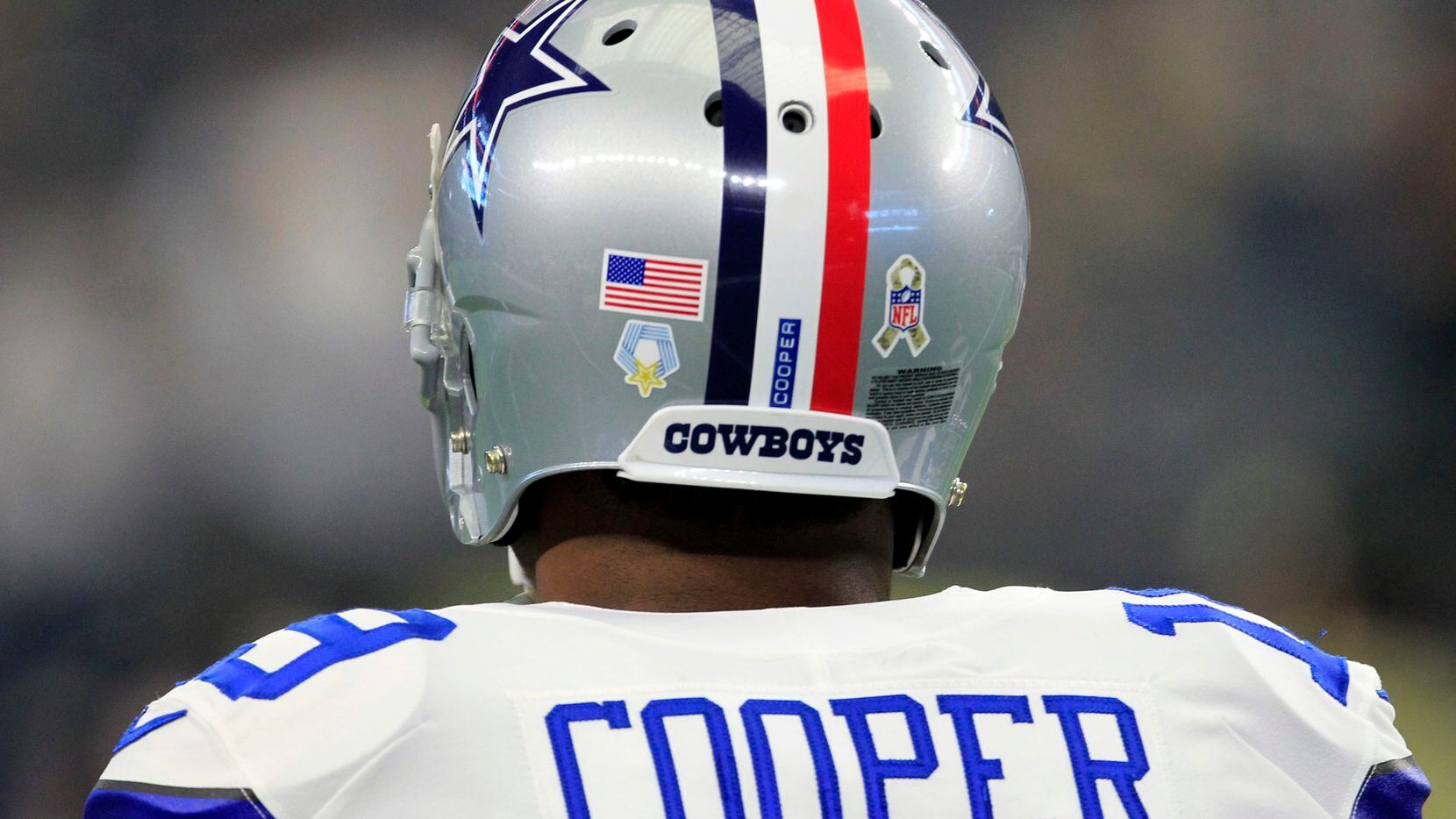 Dallas Cowboys wide receiver Amari Cooper (19) sports a helmet with red, white and blue...