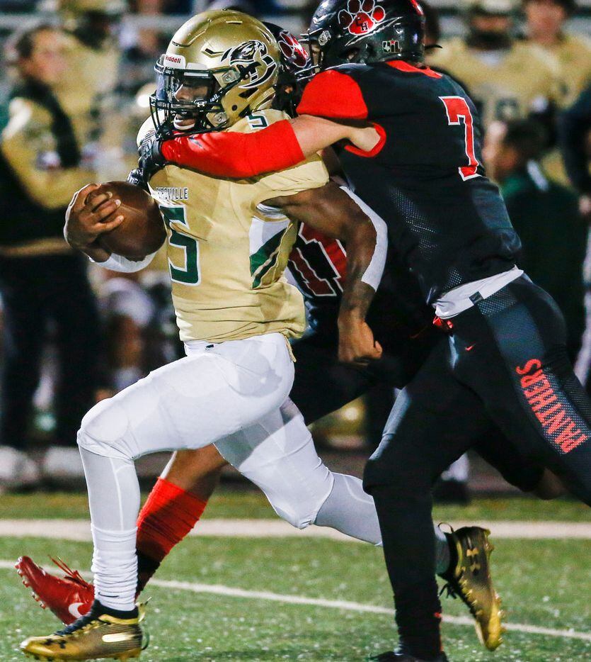 Colleyville Heritage defensive back Joshua Dobbins (11) and safety Luke Made (7) work to...