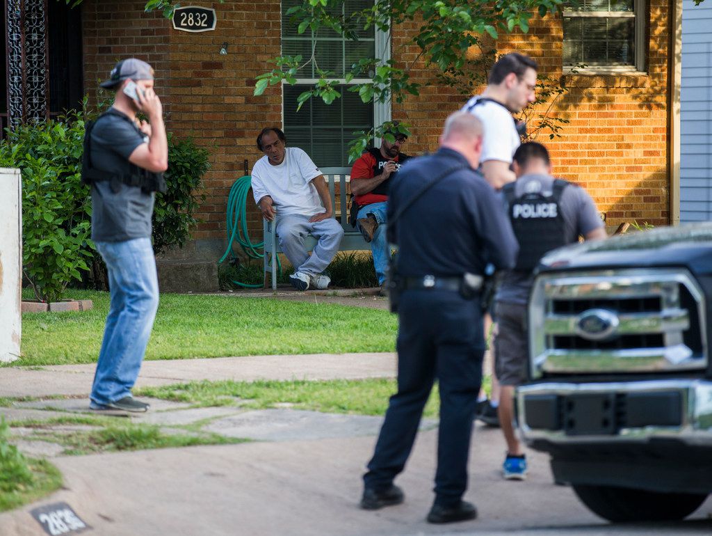Police officers stand outside a home belonging to relatives of a man who shot two officers outside a Home Depot on Tuesday, April 24, 2018 on Hedgerow Dr in Dallas. (Ashley Landis/Staff Photographer)