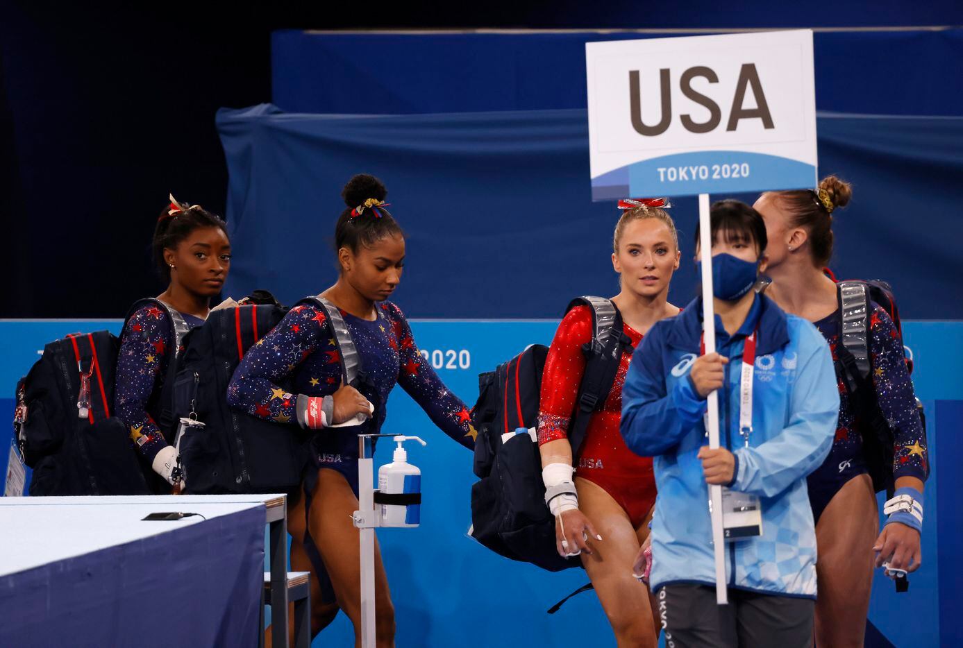 USA’s women’s gymnastics team makes their way to the uneven bars during a women’s gymnastics...