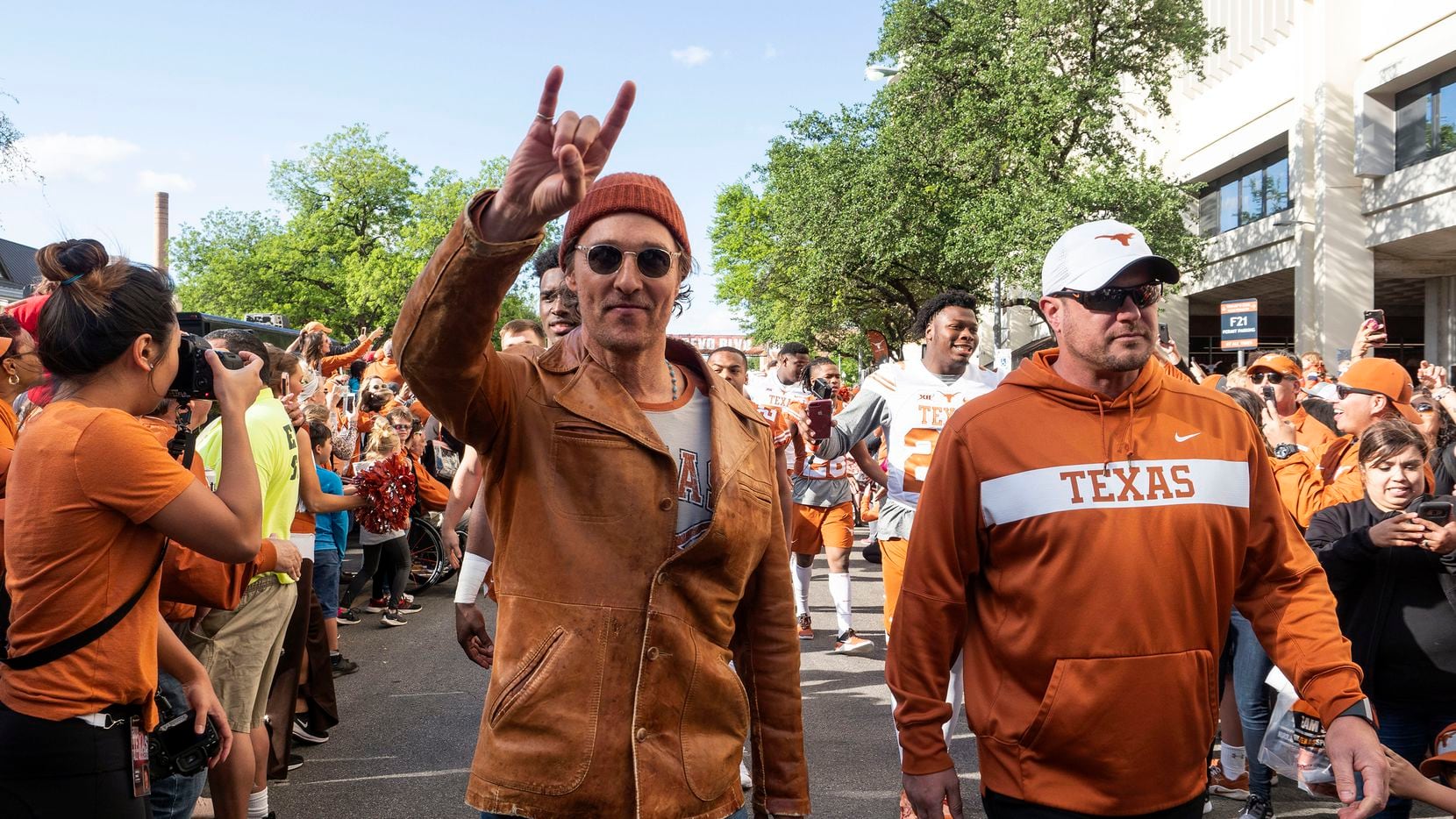 Actor Matthew McConaughey (left) and University of Texas football coach Tom Herman marched...