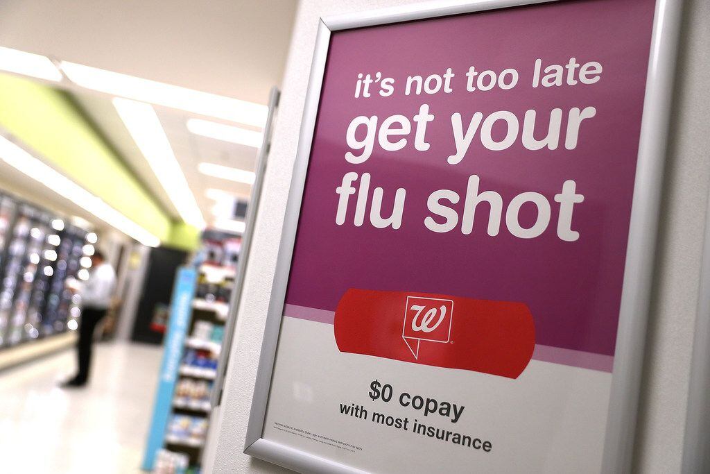 A sign advertising flu shots is displayed at a Walgreens pharmacy in San Francisco, Calif. ...