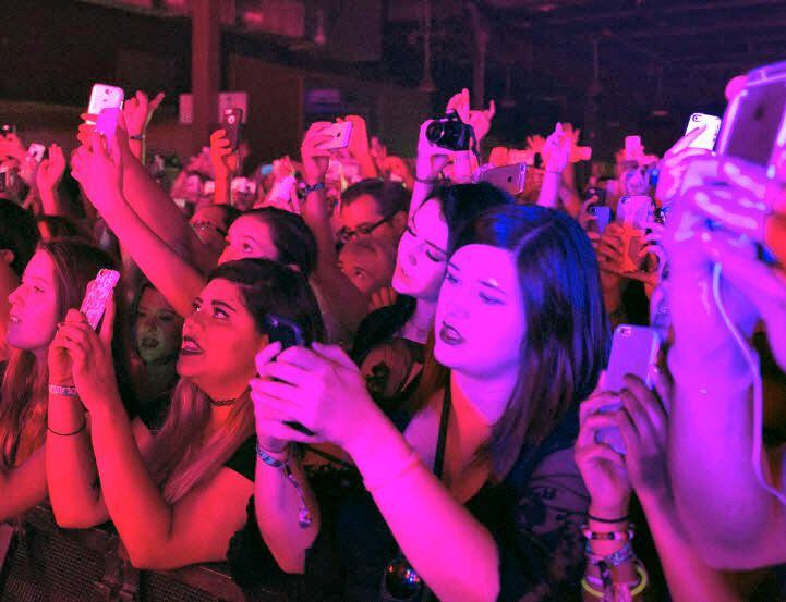 Fans hold up cell phones during the Halsey concert at South Side Music Hall. 