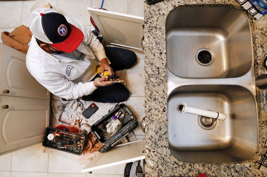 Plumber Geovanni 'Geo' Marino of Baker Brothers Plumbing prepares to sweat a copper connector under Joe Ellery's kitchen sink in Haltom City, Texas, Thursday, February 18, 2021.