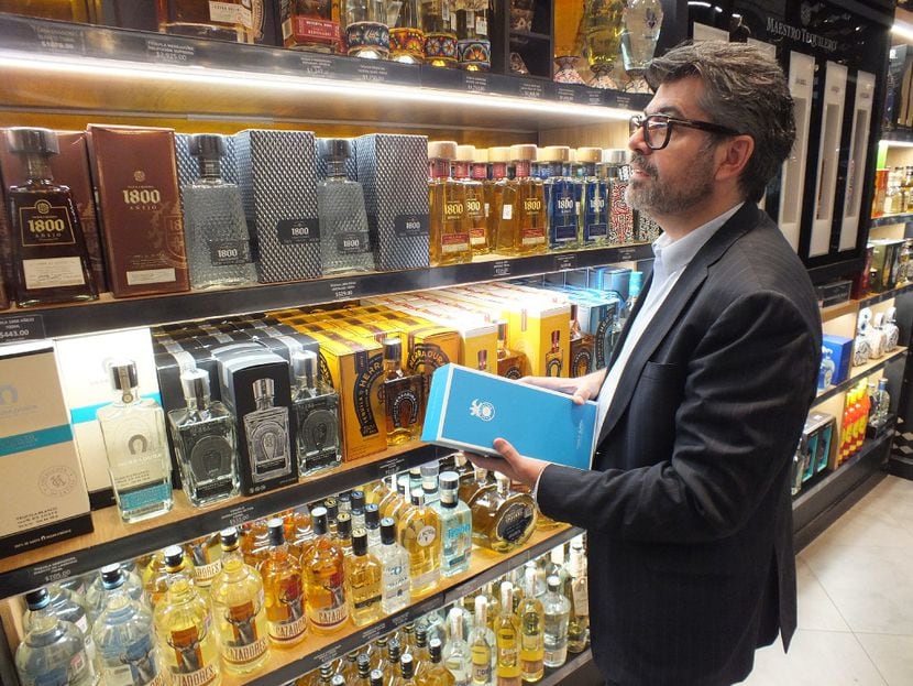 Marketing director Carlos Salcido inspects the expansive collection of tequilas for sale at...