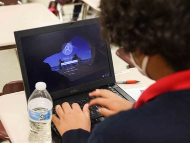 Student Francisco Gallegos tries several times to connect on a laptop during class at Palestine High School in Palestine, Texas on Thursday, March 26, 2021. (Lola Gomez/The Dallas Morning News)