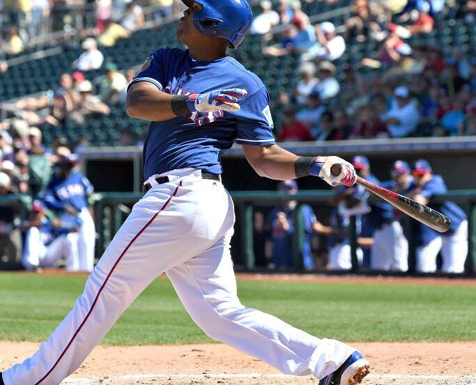 Adrian Beltre of the Texas Rangers bats against the Colorado Rockies during a spring...