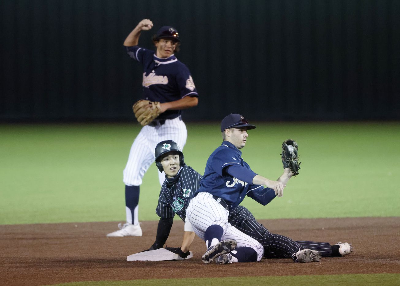 Southlake’s Max Reyes is called safe at second after an attempted tag by Keller’s Todd Baffa (2) as Mike Dattalo reacts, during a Class District 4-6A baseball game in Southlake, Texas on March 19, 2021. (Michael Ainsworth/Special Contributor)