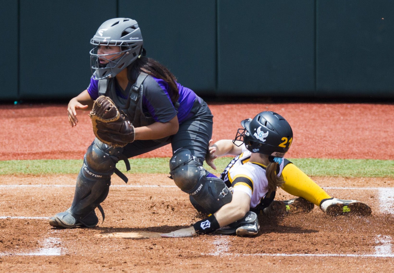 Forney's Charlie Hale (21) slides in to home for a run and collides with Angleton catcher Mika Hinojosa (13) during the second inning of a UIL Class 5A state semifinal softball game between Forney and Angleton on Friday, May 31, 2019 at Red & Charline McCombs Field at the University of Texas in Austin. (Ashley Landis/The Dallas Morning News)