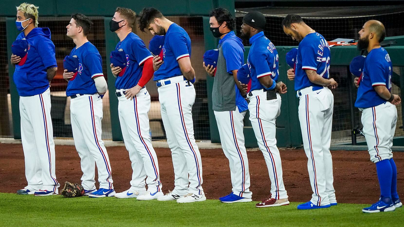 Texas Rangers players stand for the national anthem before exhibition game against the Colorado Rockies at Globe Life Field on Tuesday, July 21, 2020.