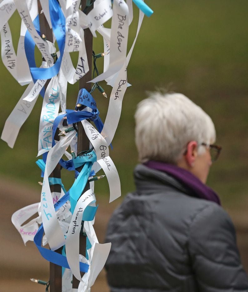 Ribbons bearing the names of loved ones who served in the military flutter in the breeze as...
