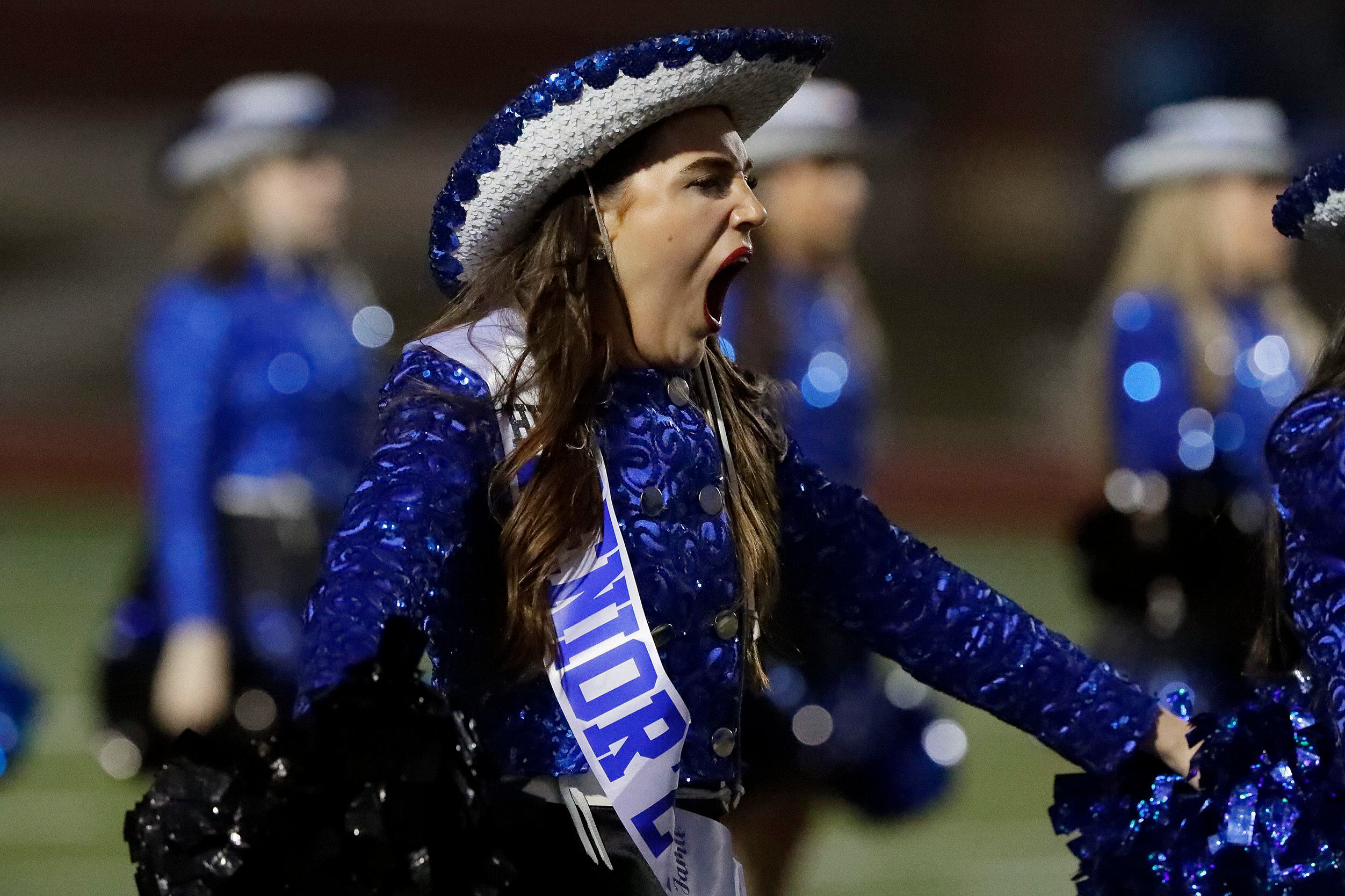Jamie Kresta with the Heritage High School Silver Wings drill team gets a yawns in before...