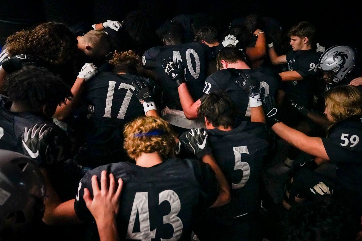 Denton Guyer players pray in the tunnel before a Class 6A Division II area-round high school...