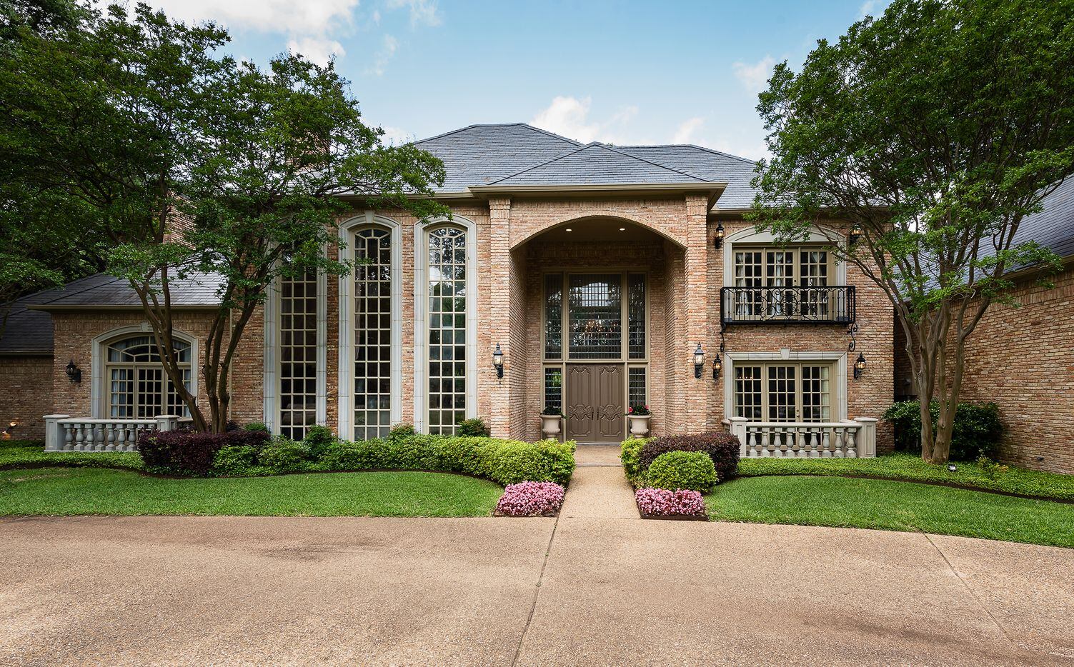Take at the exterior of the house at 9441 Hollow Way Road in Dallas, TX.