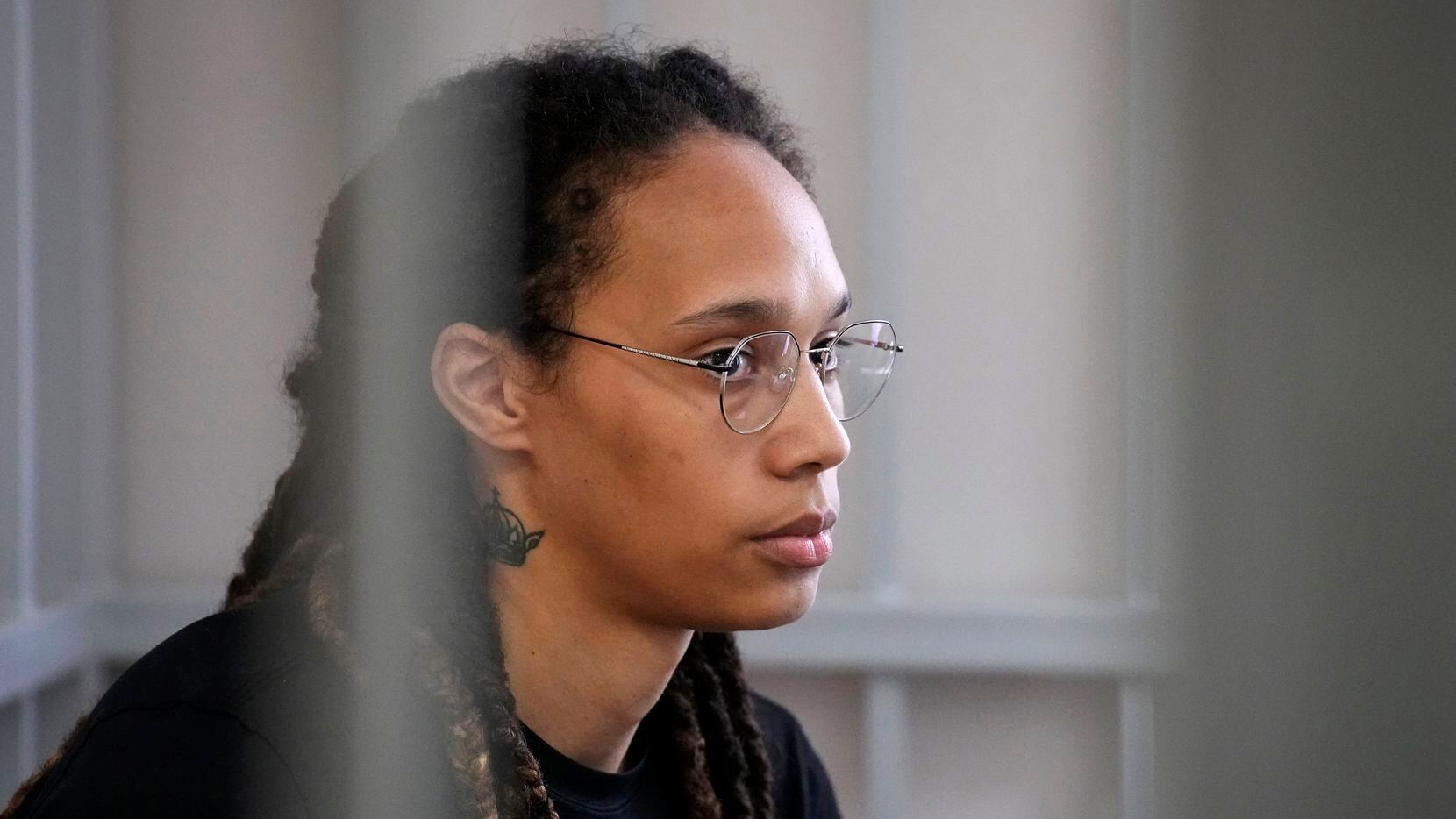 WNBA star and two-time Olympic gold medalist Brittney Griner sits in a cage at a court room...