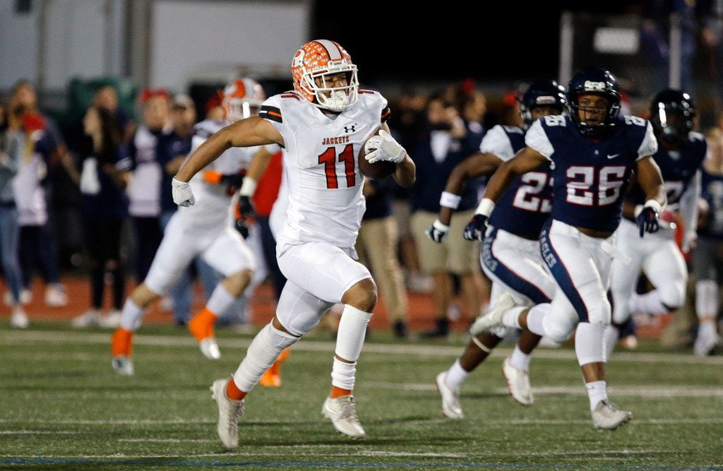 Rockwall's Jaxon Smith-Njigba (11) takes the ball to the end zone for a touchdown during the...