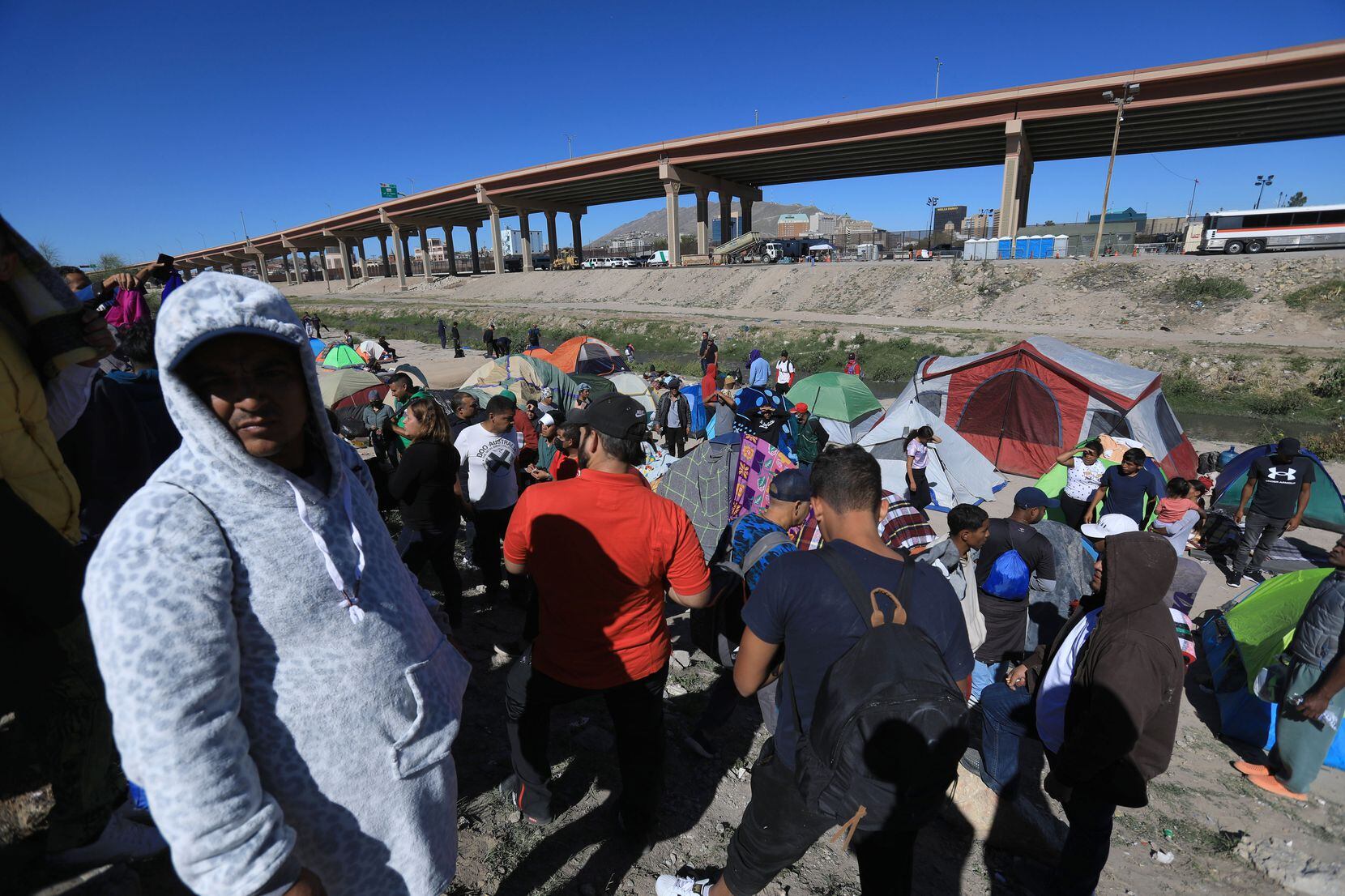 Dozens of migrants expelled from the Unites States set up a camp along the Rio Grande in...