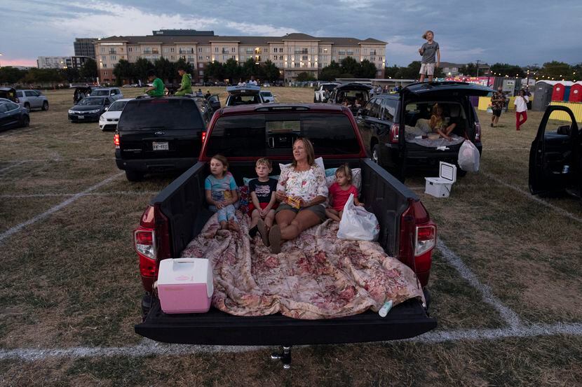 Angie Davis, 53, of Rowlett, sits in the back of her pick-up truck with her grandchildren as...