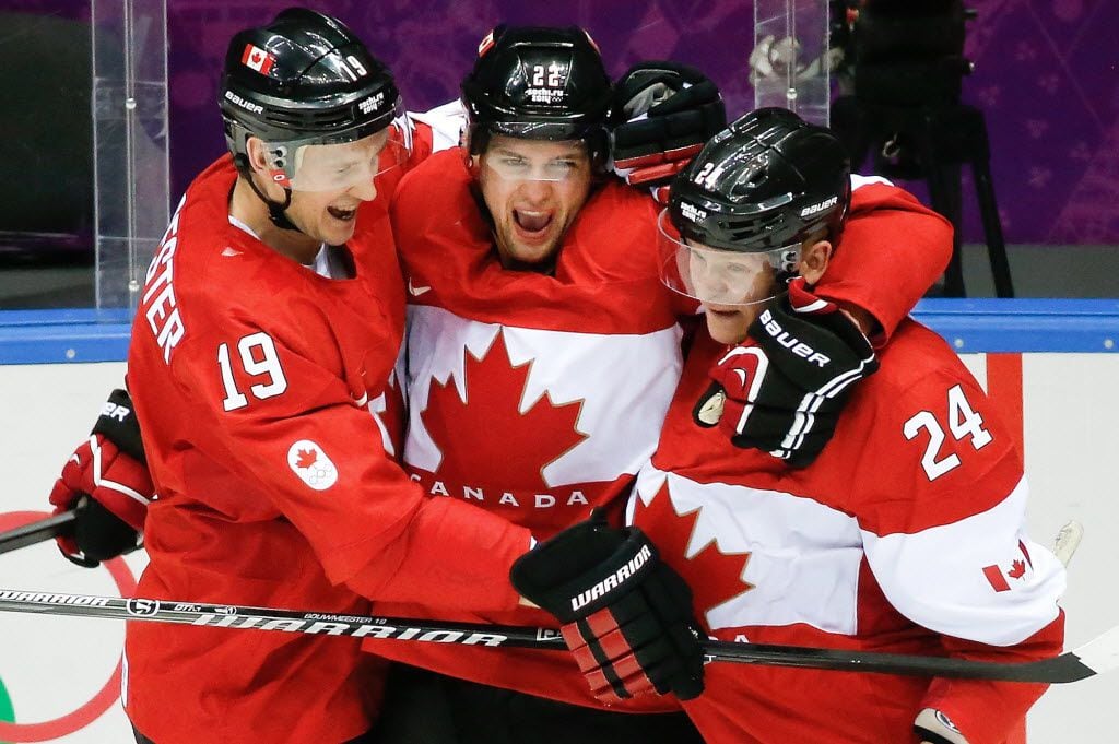 Canada forward Jamie Benn, center, celebrates his goal against the USA with teammates Jay...