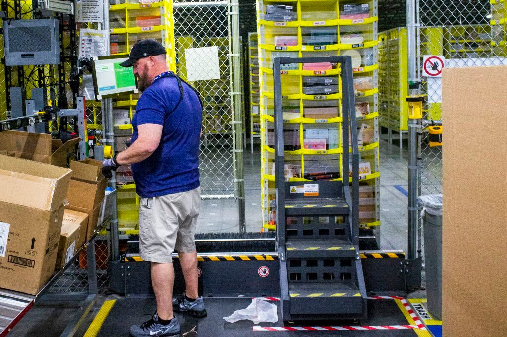 Salvador Ribaul organize packages at an Amazon fulfillment center in Grapevine in December.