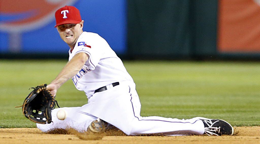 Texas Rangers second baseman Josh Wilson (12) snares a grounder to get Houston Astros right...