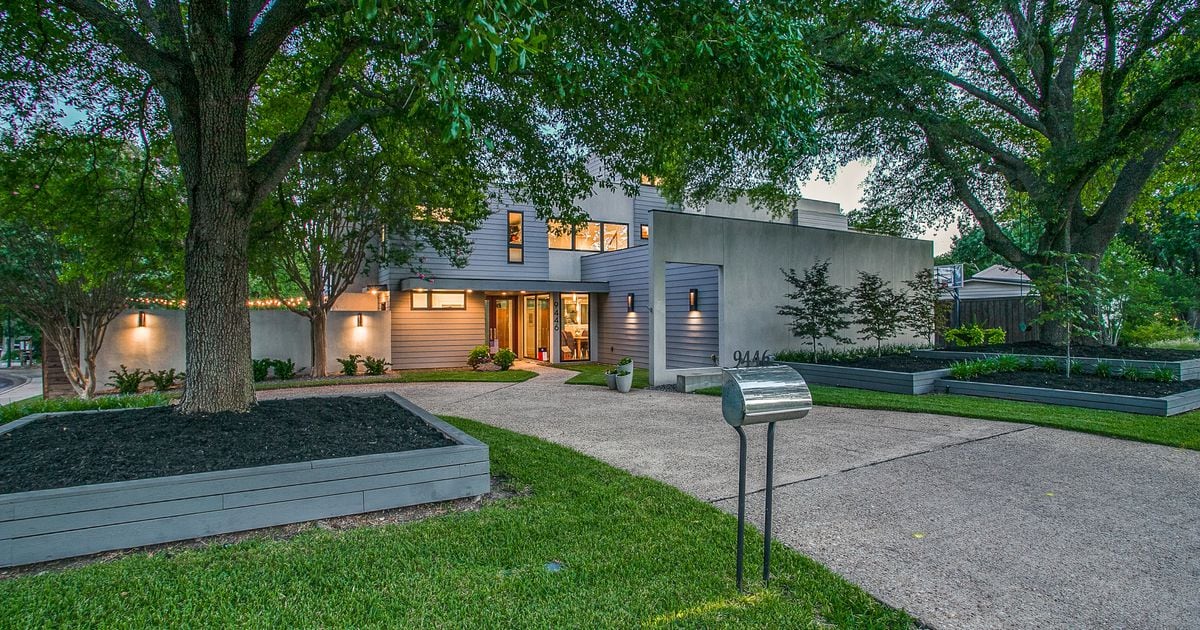 In Lake Highlands, a modern home with green views has two kitchen islands