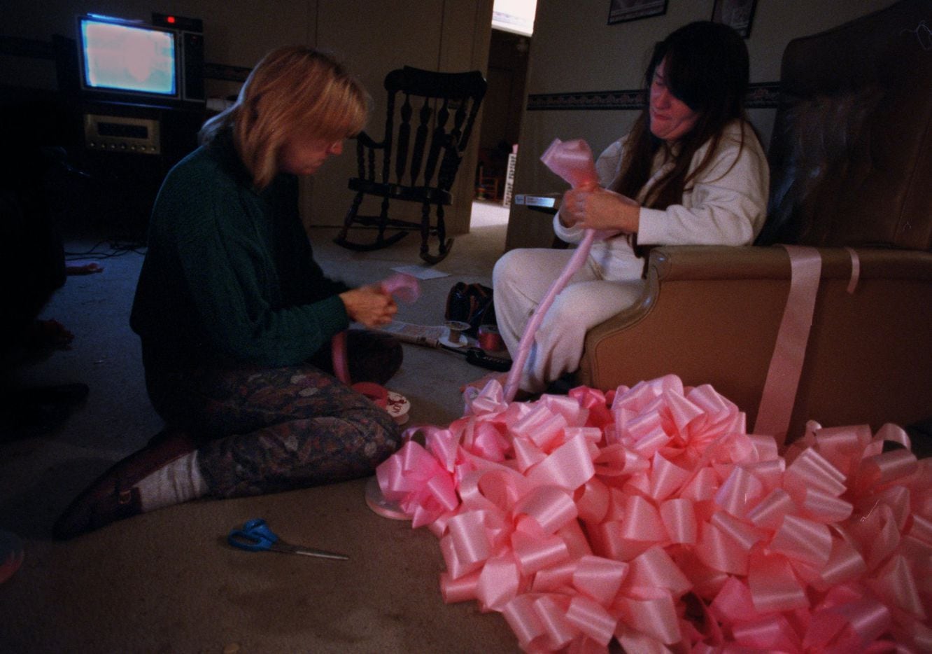 Barbara Dyess and Tammy Zimmerman make pink bows at 3 a.m. on Jan. 18, 1996 for Amber Hagerman as they await word on the identity of a child's body which had been found earlier that evening. Zimmerman, who was crying as she tied the bows, said they were  going to continue despite the outcome of the news.