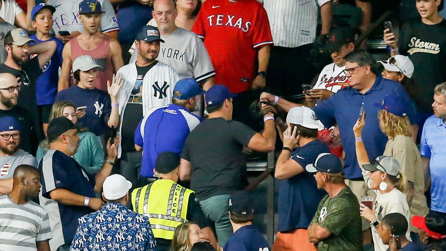 The Texas Rangers fan, (center blue hat) who caught New York Yankees’ outfielder Aaron...