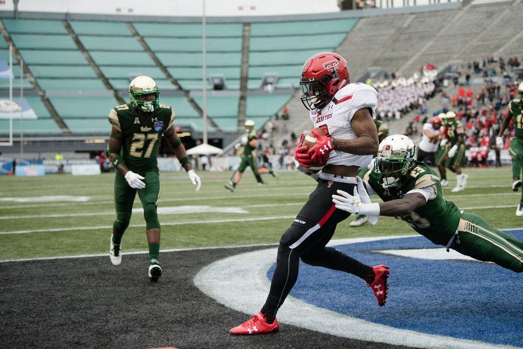 Texas Tech wide receiver Keke Coutee (2) catches a touchdown pass as South Florida cornerback Mazzi Wilkins (23) attempt to stop him during the Birmingham Bowl NCAA college football game, Saturday, Dec. 23, 2017 in Birmingham, Ala. (AP Photo/Albert Cesare)