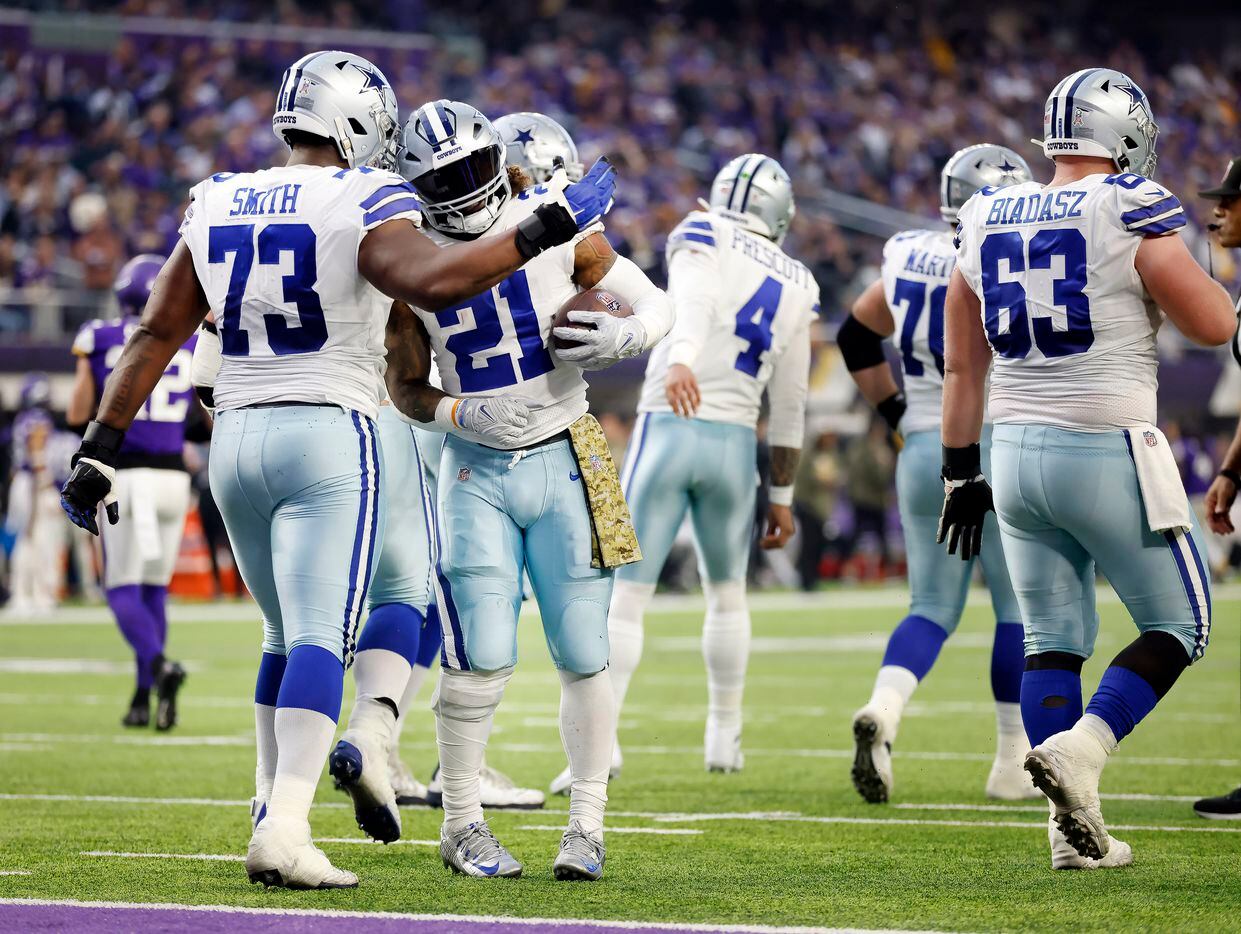 Dallas Cowboys running back Ezekiel Elliott (21) is congratulated on his touchdown dive by...