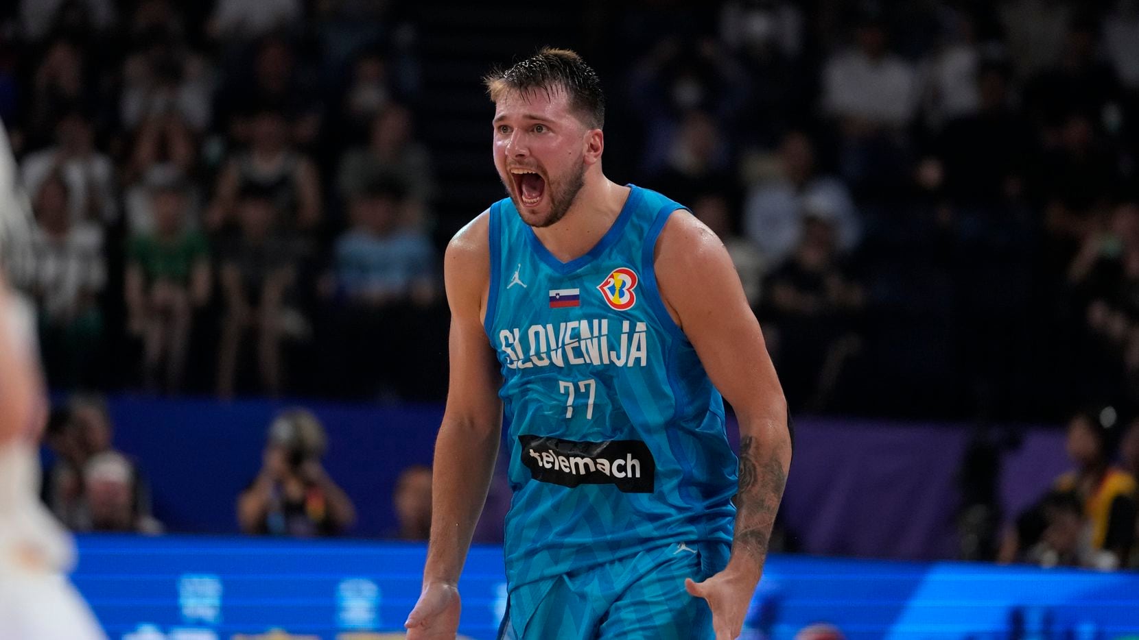 Slovenia guard Luka Doncic (77) reacts during the first half of a Basketball World Cup Group...