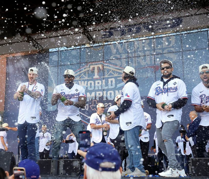Texas Rangers players spray the crowd with champagne following their World Series Victory...