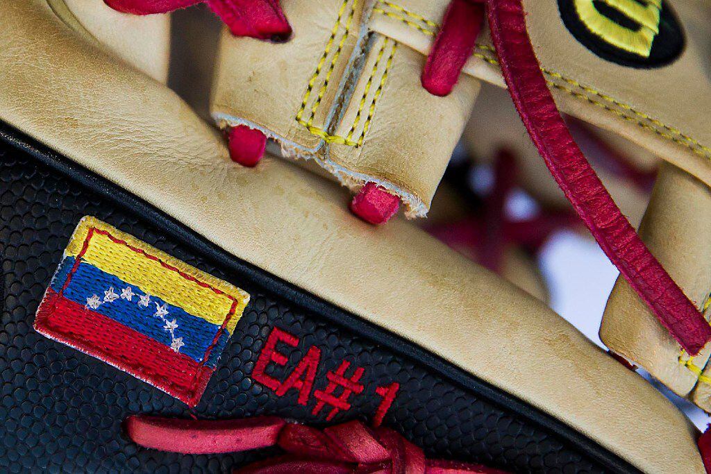 The flag ov Venezuela on the glove of Texas Rangers shortstop Elvis Andrus before a game...