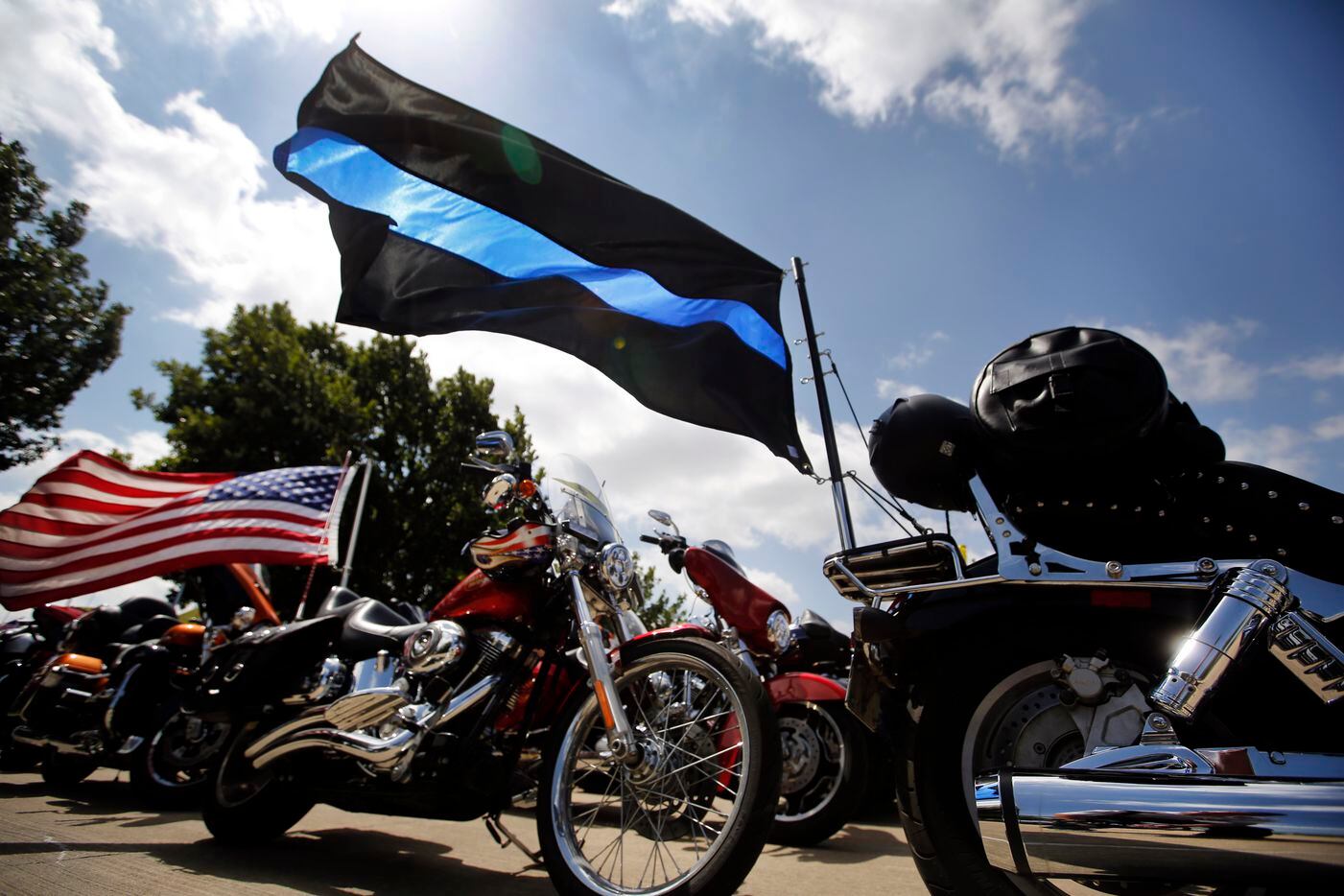 A 'Thin Blue Line' flag representing fallen officers was among those on display outside...