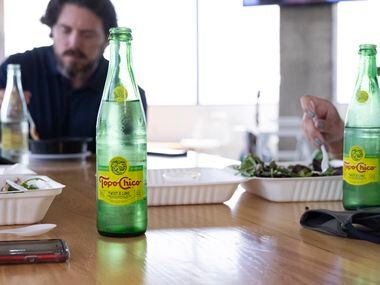 Employees enjoy Topo Chico during lunch on Sept. 2 at the Camelot office in Dallas.