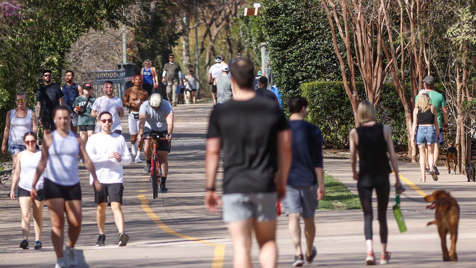 Crowds of people walk down Katy Trail,Sunday, March, 27, 2022 in Dallas, Texas. An Air...