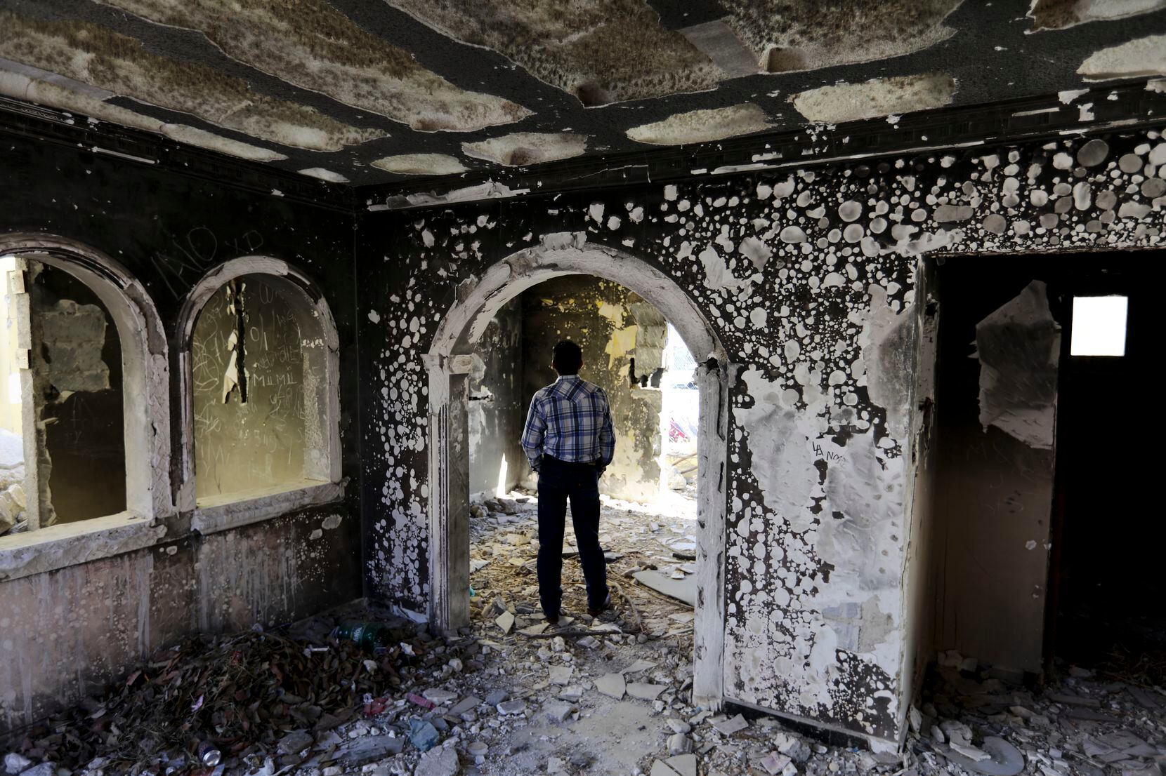A former policeman in December 2019 walked through an abandoned home that was torched by the Zetas cartel in Allende, Mexico, in 2011 in an act of revenge.