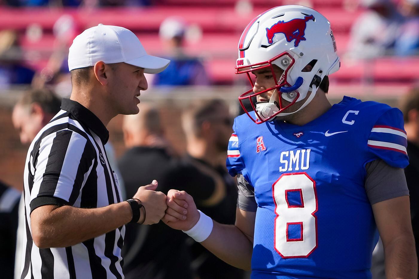 SMU quarterback Tanner Mordecai (8) fist bumps an official before an NCAA football game...