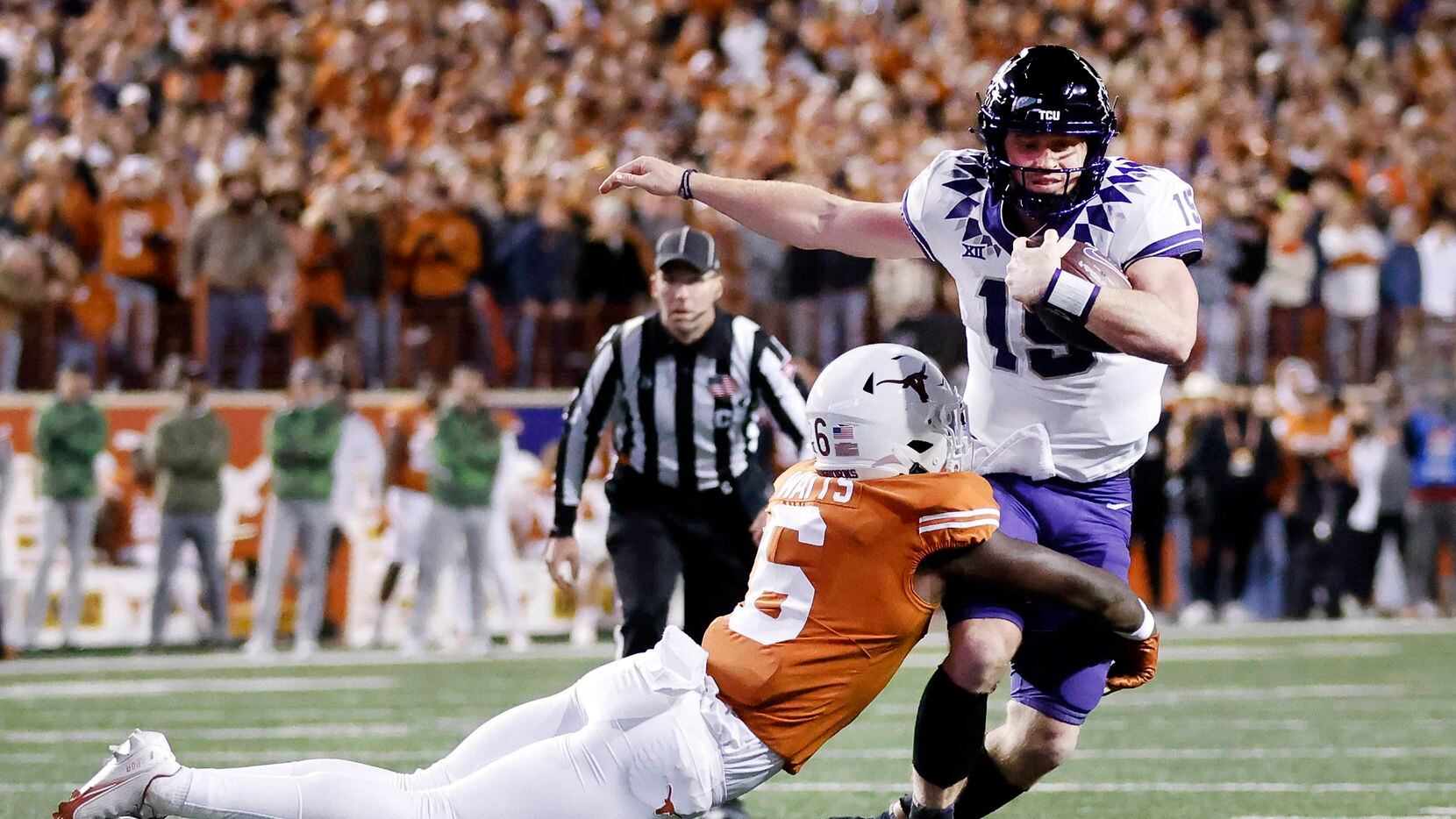 TCU Horned Frogs quarterback Max Duggan (15) is tackled in the open field by Texas Longhorns...
