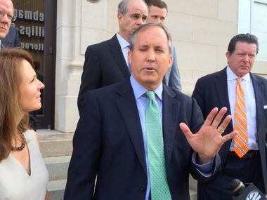 Surrounded by his wife and lawyers, Texas Attorney General Ken Paxton speaks on Friday,...