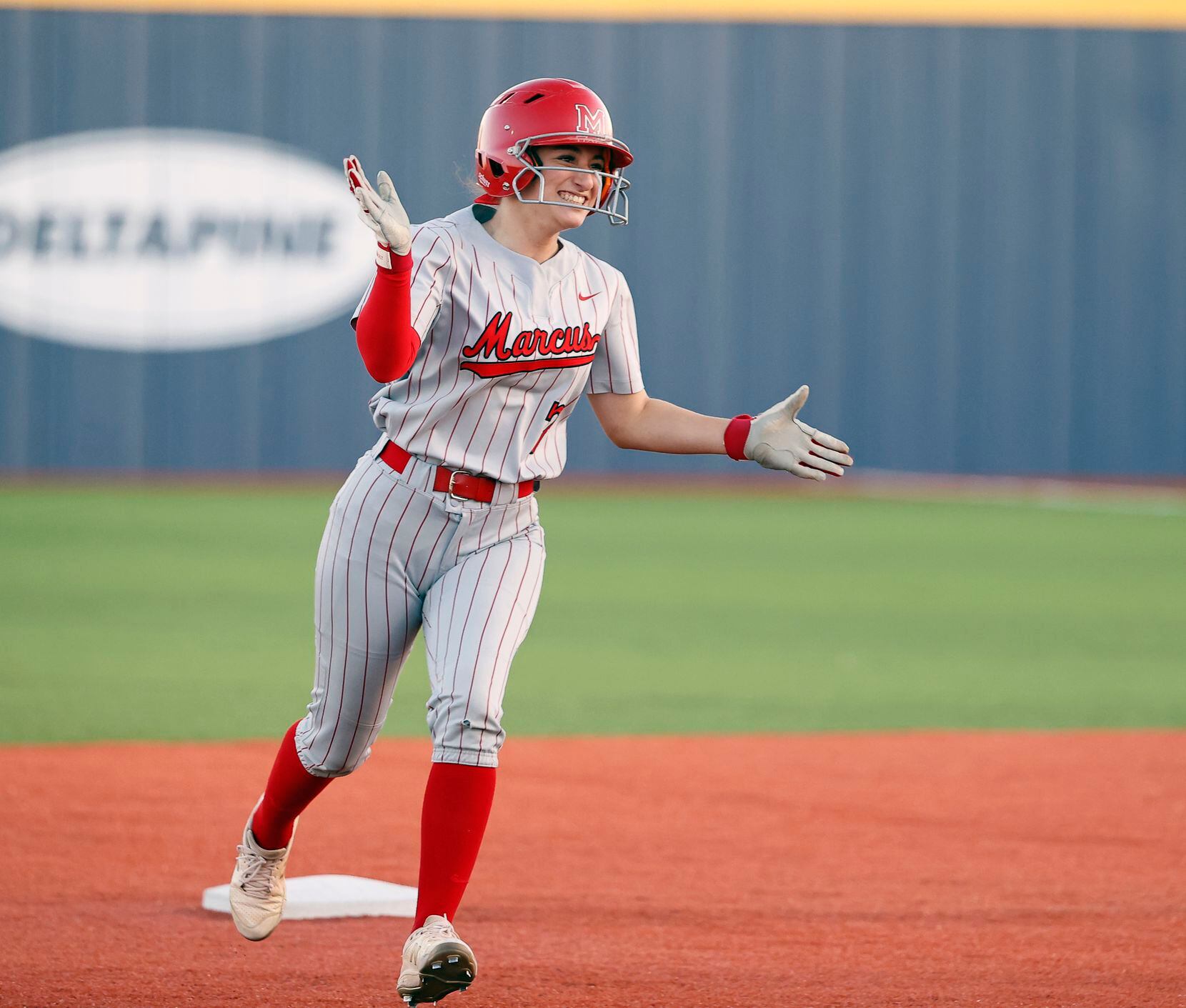 Flower Mound Marcus' Alexa Hanish (7) celebrates after hitting a home run during the game...