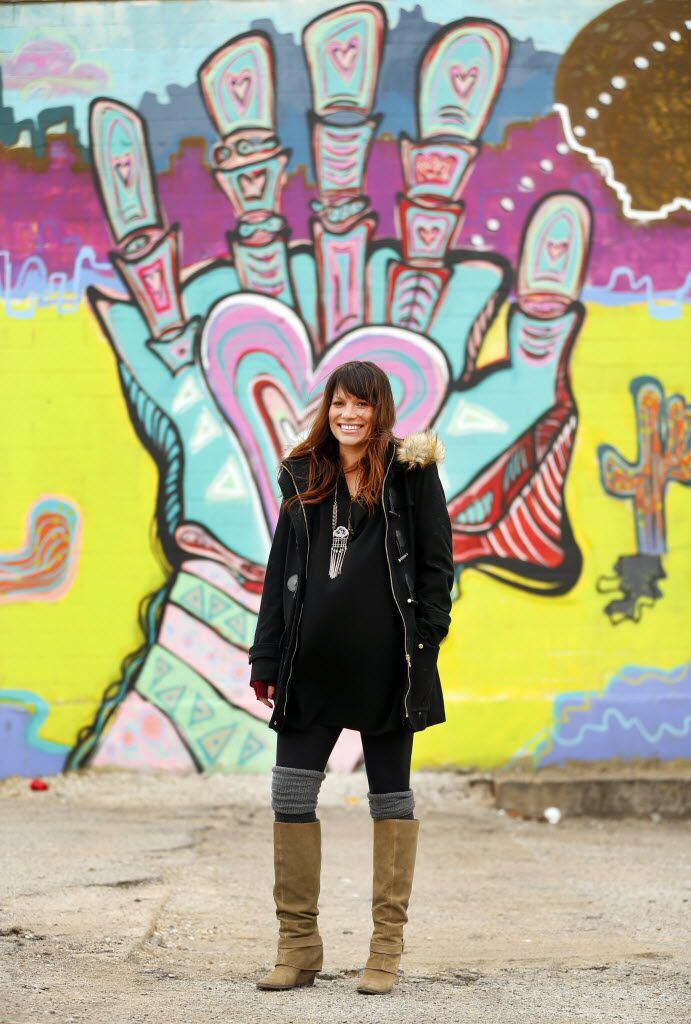 Artist Lesli Marshall poses in front of her mural Cosmic Journey. The piece, on the back side of Pecan Lodge, is part of the 42 Murals project in the Deep Ellum area of Dallas. (Tom Fox/The Dallas Morning News)